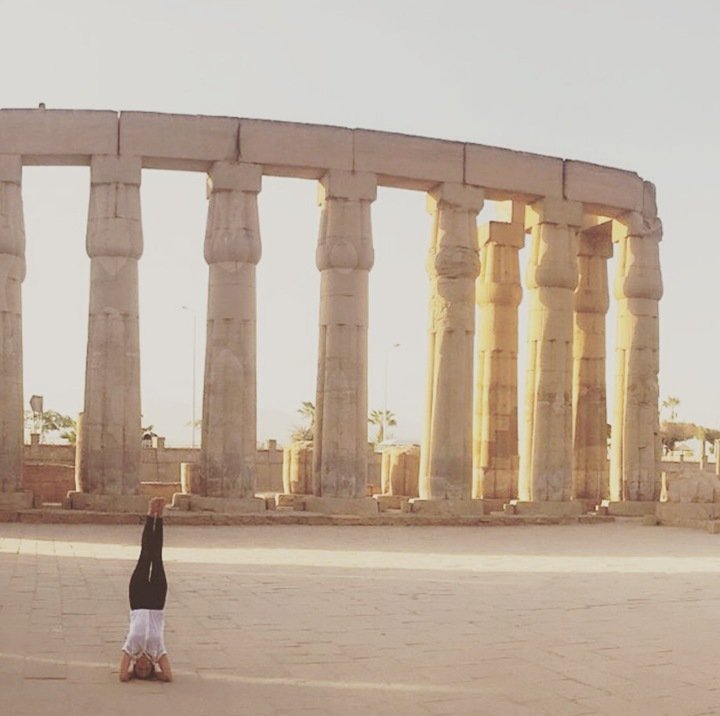 Ryen Toft headstand among stone columns